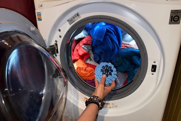 Rachael Z. Miller, founder of the Vermont-based Rozalia Project for a Clean Ocean, tosses a Cora Ball, a laundry ball that can be tossed into the washer to cut down on clothes banging into each other, on Thursday, April 17, 2025, in Granville, Vt. (AP Photo/Amanda Swinhart)