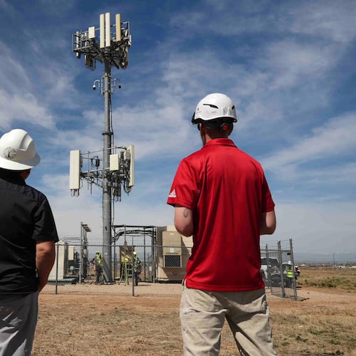 Workers observe a tower where Pano AI cameras are installed for detecting wildfires Monday, April 20, 2026, in Aurora, Colo. (AP photo/Brittany Peterson)
