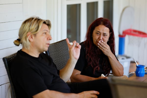 Débora Rey reacts as her husband Martín Verdi speaks. They are trying to navigate the legal proceedings after their son Agustin, was detained and held at Stewart Detention Center in Lumpkin, April 27, 2025. (Miguel Martinez/ AJC)