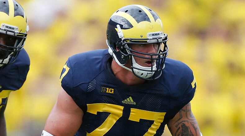 ANN ARBOR, MI - AUGUST 31: Taylor Lewan #77 of the Michigan Wolverines lines up with Louis Palmer #56 of the Central Michigan Chippewas during the first quarter at Michigan Stadium on August 31, 2013 in Ann Arbor, Michigan. (Photo by Gregory Shamus/Getty Images) ANN ARBOR, MI - AUGUST 31: Taylor Lewan #77 of the Michigan Wolverines lines up with Louis Palmer #56 of the Central Michigan Chippewas during the first quarter at Michigan Stadium on August 31, 2013 in Ann Arbor, Michigan. (Photo by Gregory Shamus/Getty Images)