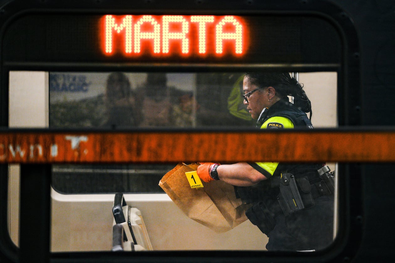 A MARTA police officer collects evidence from a train at the Midtown station on Friday, June 5, 2026. (Ben Hendren for the AJC)