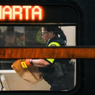 A MARTA police officer collects evidence from a train after a shooting at the Midtown station on June 5. Anthony Gresham was arrested in connection to the incident, which police said injured a teen. (Ben Hendren for the AJC)