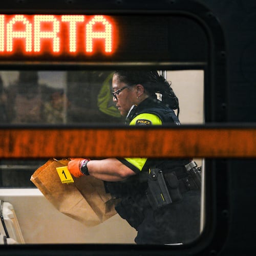 A MARTA police officer collects evidence from a train at the Midtown station on Friday, June 5, 2026. (Ben Hendren for the AJC)