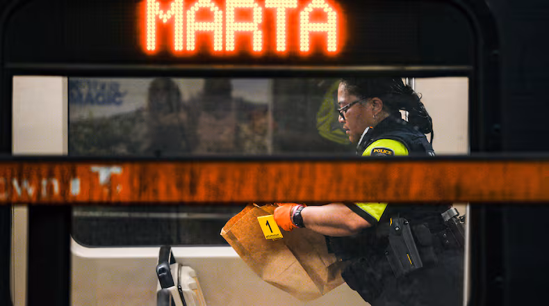 A MARTA police officer collects evidence from a train at the Midtown station on Friday, June 5, 2026. (Ben Hendren for the AJC)