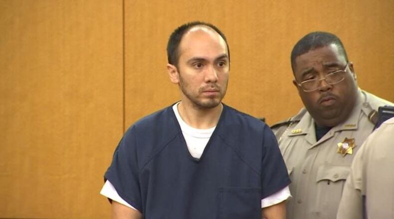 Michael Morgan is escorted into a Fulton County courtroom on Friday, May 26.