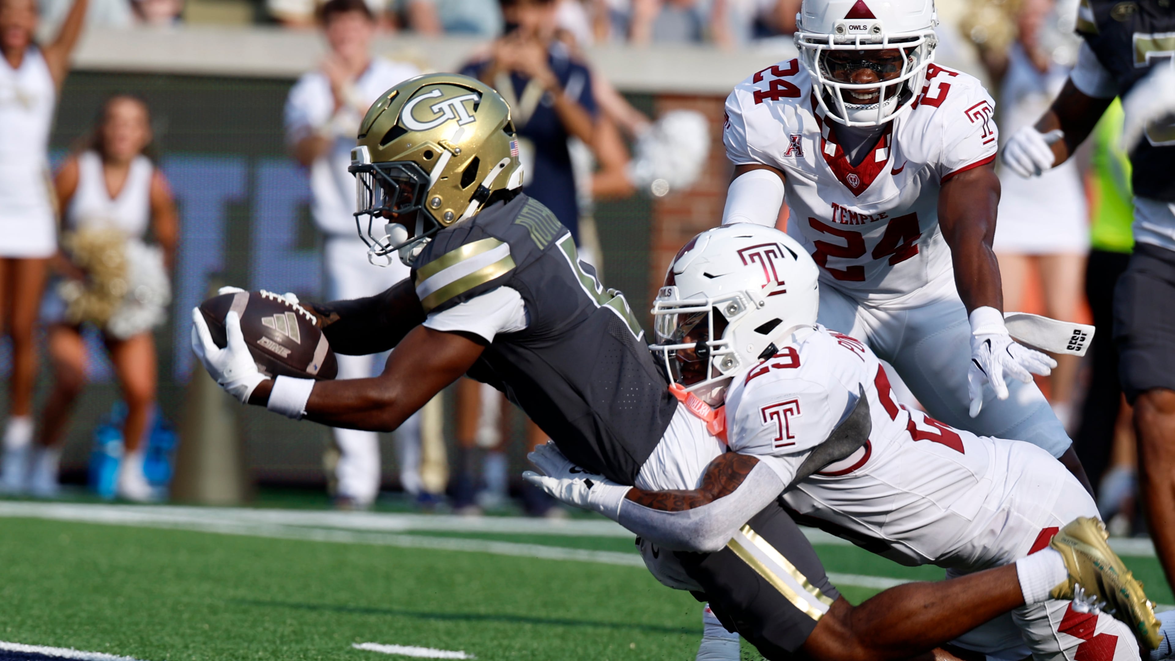 Georgia Tech wide receiver Malik Rutherford, left, dives for the end zone as Temple safety Avery Powell (29) defends during the first half of an NCAA college football game, Saturday, Sept. 20, 2025, in Atlanta. (AP Photo/Butch Dill)