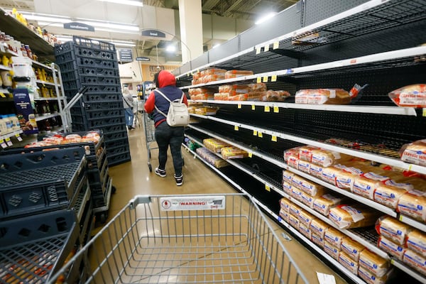 Residents began clearing shelves at an Atlanta Kroger on Friday, Jan. 23, 2026, as a winter storm was forecast to hit metro Atlanta this weekend. Gov. Brian Kemp declared a state of emergency for all 159 counties, advising residents to gather supplies and prepare to “hunker down” in case of power outages.  (Miguel Martinez/AJC)