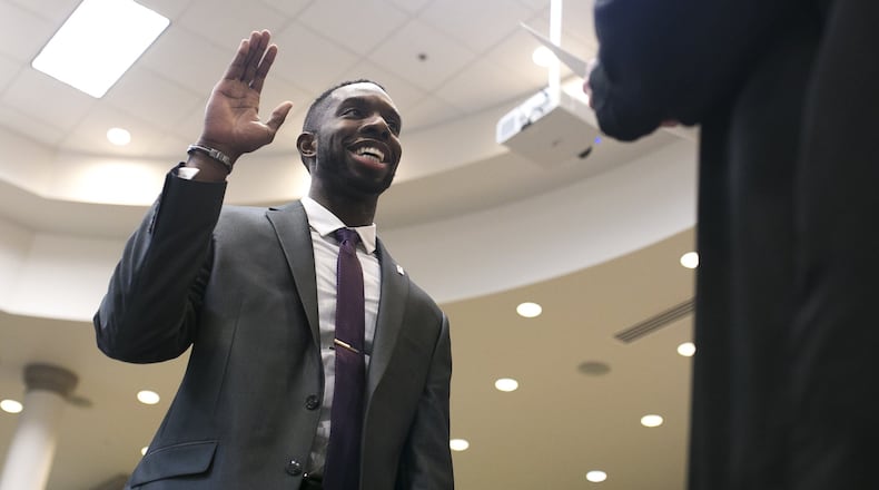 12-20-18 - Suwanee, GA - Everton Blair takes an oath during his swearing in ceremony at the Gwinnett County Board of Education office in Suwanee, Ga., on Thursday, Dec. 20, 2018. Blair will be the first black member of the Gwinnett County Board of Education, as well as the youngest. (Casey Sykes for The Atlanta Journal-Constitution)
