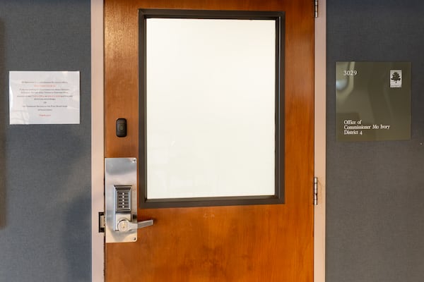 A code must be used to open this door, which leads to a hallway and offices that were being used temporarily by Commissioner Mo Ivory and members of her staff at the Fulton County Government Center. (Ben Hendren for the AJC)