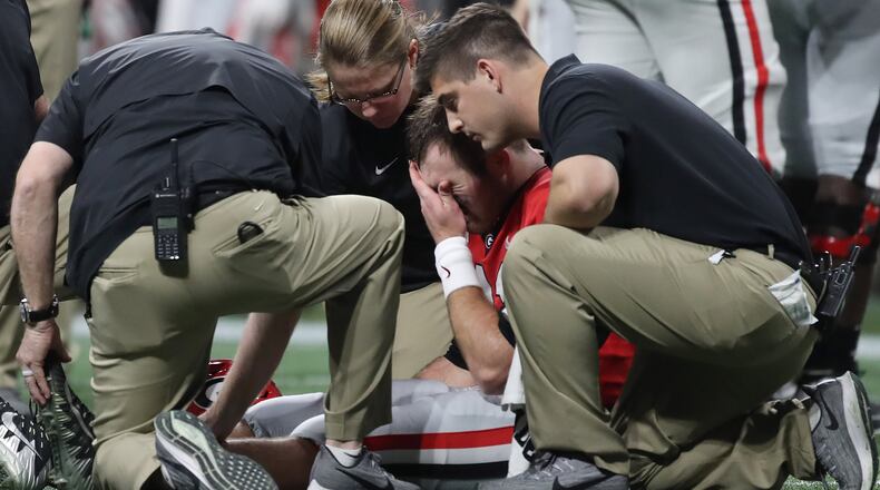 12/7/19 - Atlanta - Georgia Bulldogs quarterback Jake Fromm (11) is injured during the first half of the Georgia vs. LSU SEC Football Championship game at Mercedes-Benz Stadium in Atlanta. Alyssa Pointer / alyssa.pointer@ajc.com