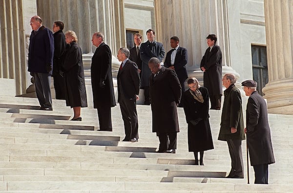 WASHINGTON, :  L-R Chief Justice of the US Supreme Court William Rehnquist, and justices Sandra Day O'Connor, Anthony Kennedy, David Souter, Clarence Thomas, Ruth Bader Ginsburg, Stephen Breyer and John Paul Stevens stand on the steps in front of the Supreme Court waiting for pallbearers to bring the casket of former justice Harry Blackmun into the building where it lie in state. Blackmun died in 1999 at the age of 90.