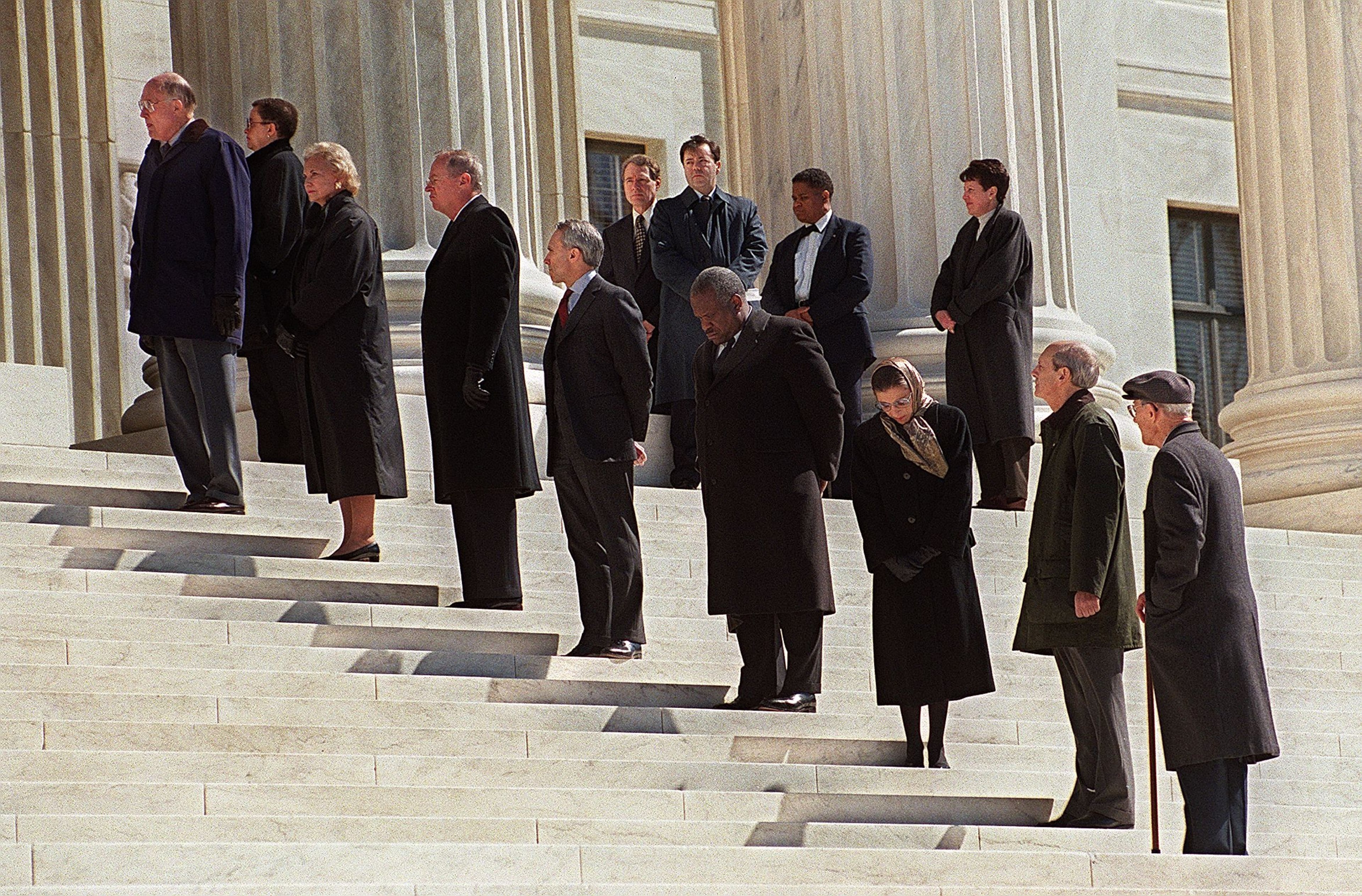 WASHINGTON, : L-R Chief Justice of the US Supreme Court William Rehnquist, and justices Sandra Day O'Connor, Anthony Kennedy, David Souter, Clarence Thomas, Ruth Bader Ginsburg, Stephen Breyer and John Paul Stevens stand on the steps in front of the Supreme Court waiting for pallbearers to bring the casket of former justice Harry Blackmun into the building where it lie in state. Blackmun died in 1999 at the age of 90.