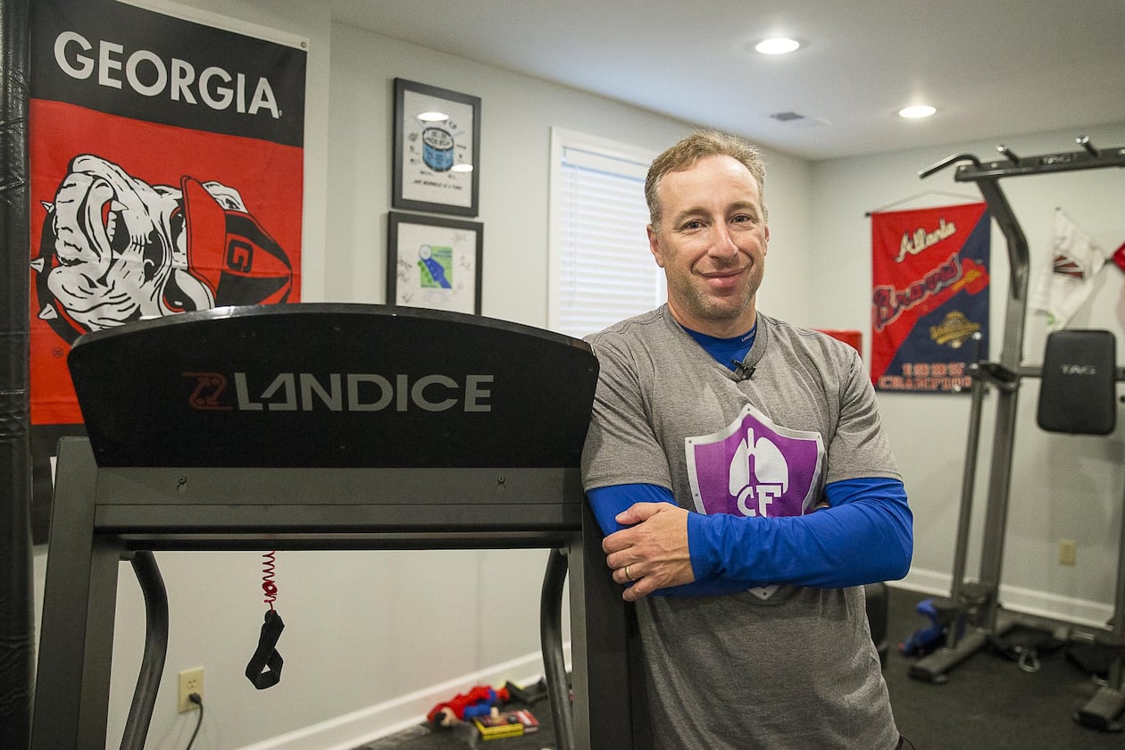 Andy Lipman in a workout room at his home. Despite being diagnosed with cystic fibrosis in childhood, he lived a full life and became a spokesman for not letting problems limit one's accomplishments. ALYSSA POINTER / ALYSSA.POINTER@AJC.COM