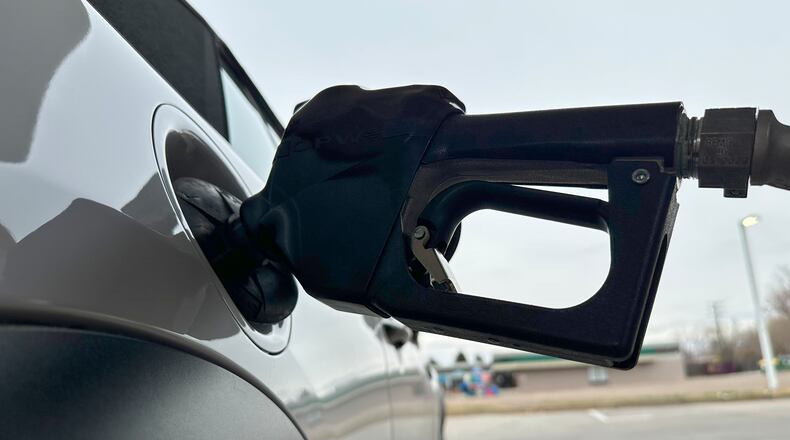FILE - A motorist fills up the tank of a vehicle at a gasoline station Sunday, Nov. 30, 2025, in Littleton, Colo. (AP Photo/David Zalubowski, File)