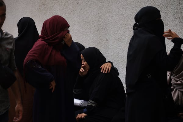 Mourners attend the funeral of Palestinians who were killed by an Israeli airstrike, at Shifa Hospital in Gaza City Tuesday, July 15, 2025. (AP Photo/Jehad Alshrafi)
