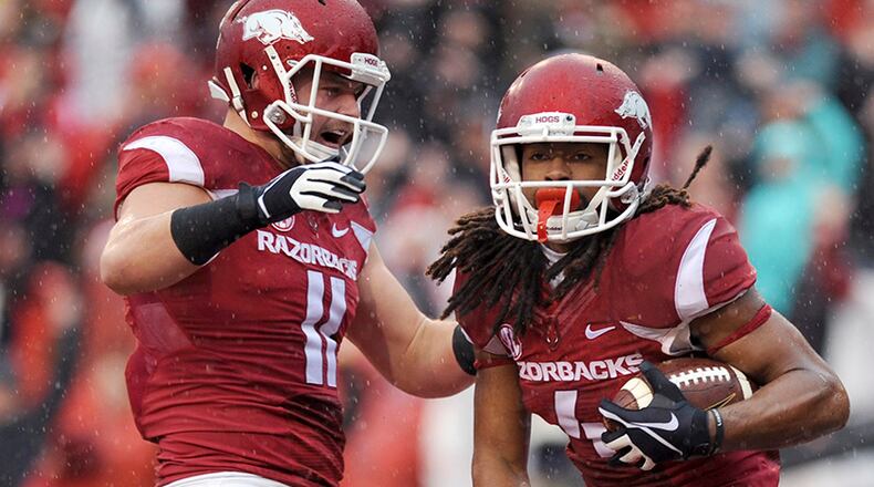 Arkansas tight end AJ Derby (11) celebrates with wide receiver Keon Hatcher (4) after Hatcher's first quarter touchdown in an NCAA college football game against Mississippi Saturday, Nov. 22, 2014, in Fayetteville, Ark. (AP Photo/Sarah Bentham)