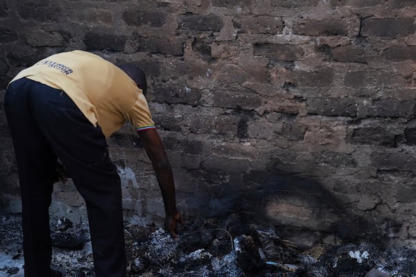 A man looks at a burned house following an attack by gunmen in Yelewata community north-central Nigeria, Monday, June 16, 2025. (AP Photo)