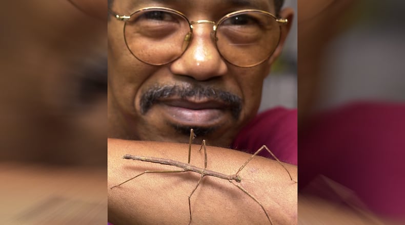 Insect expert Dr. Duane Jackson of Morehouse College, posing with a Vietnamese walking stick, also served with Zoo Atlanta and influenced a generation of students. (AJC File)