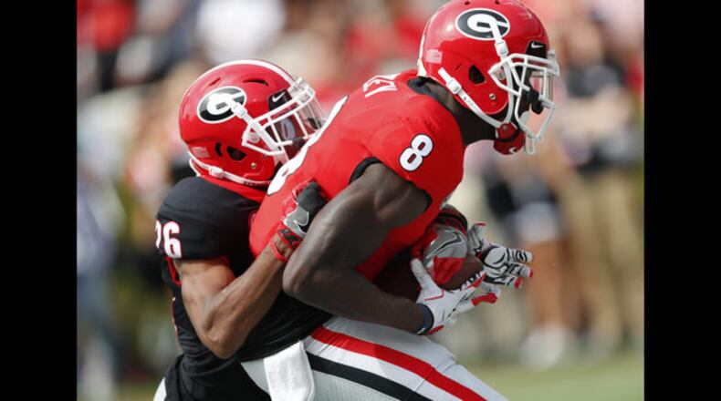 Georgia wide receiver Trey Blount (14) and defensive back D"Andre Walker battle fro the ball during the first half of the G day intrasquad spring college football game Saturday, April 21, 2018, in Athens, Ga. (AP Photo/John Bazemore)