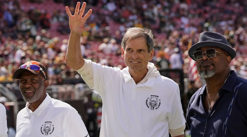 FILE - Former Cleveland Browns quarterback Bernie Kosar waves during a Browns' Alumni event before an NFL football game between the Green Bay Packers and the Cleveland Browns in Cleveland, Sunday, Sept. 21, 2025. (AP Photo/Sue Ogrocki, File)