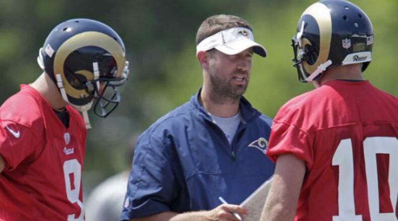 Brian Schottenheimer working last year with quarterbacks Austin Davis (9) and Kellen Clemons (10).