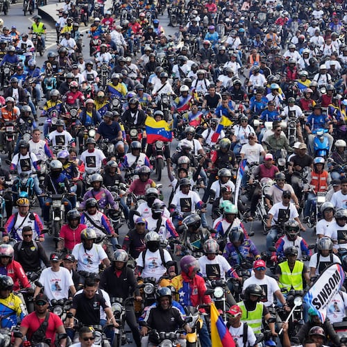 Supporters of former Venezuelan President Nicolas Maduro ride through the streets calling for his release as he faces trial in the United States after being captured by U.S. forces, in Caracas, Venezuela, Tuesday, Jan. 13, 2026. (AP Photo/Matias Delacroix)