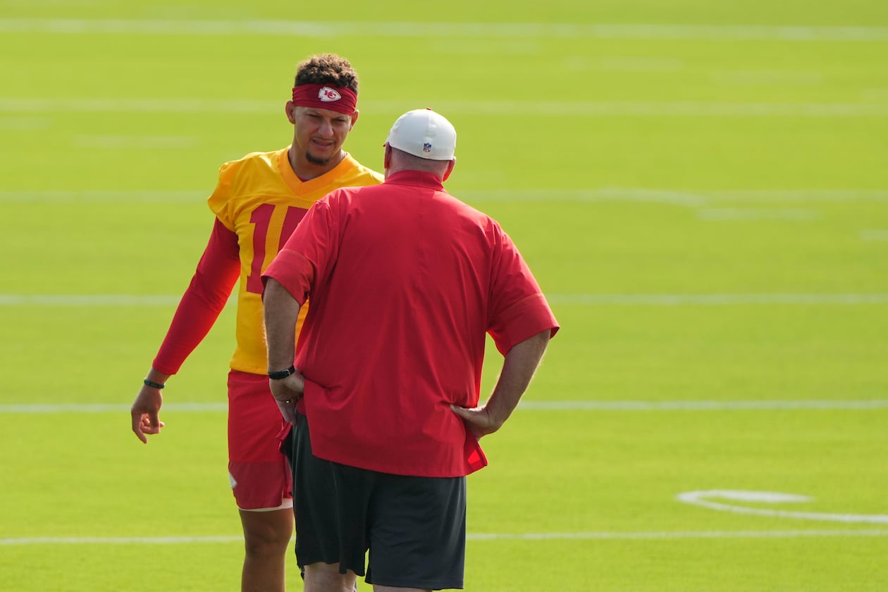 Kansas City Chiefs quarterback Patrick Mahomes talks with head coach Andy Reid at NFL football training camp Saturday, July 25, 2026, in St. Joseph, Mo. (AP Photo/Charlie Riedel)