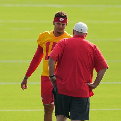 Kansas City Chiefs quarterback Patrick Mahomes talks with head coach Andy Reid at NFL football training camp Saturday, July 25, 2026, in St. Joseph, Mo. (AP Photo/Charlie Riedel)