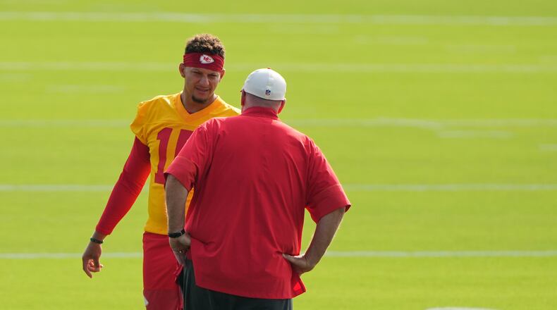 Kansas City Chiefs quarterback Patrick Mahomes talks with head coach Andy Reid at NFL football training camp Saturday, July 25, 2026, in St. Joseph, Mo. (AP Photo/Charlie Riedel)