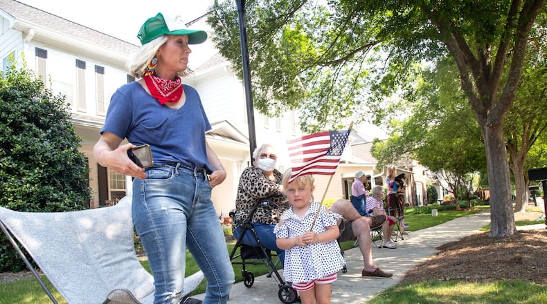 Jennifer Fitzgerald (L) and her daughter Vivian, 3, linger after the fourth of July Drive-By Parade, passed through the neighborhood in Powder Springs Saturday, July 4, 2020. STEVE SCHAEFER FOR THE ATLANTA JOURNAL-CONSTITUTION