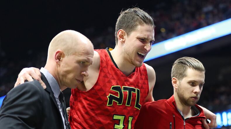 Hawks’ Mike Muscala grimaces with an apparent injury against the Bucks in the first half of a NBA basketball game on Sunday, Jan. 15, 2017, in Atlanta. Muscala left the game and did not return. Curtis Compton/ccompton@ajc.com