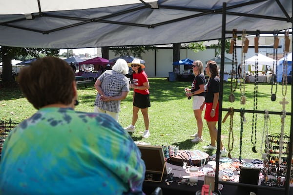 Campaign volunteers for Republican gubernatorial candidate Burt Jones walk through the farmers market in his hometown, Jackson, on Saturday, June 6, 2026. (Abbey Cutrer/AJC)