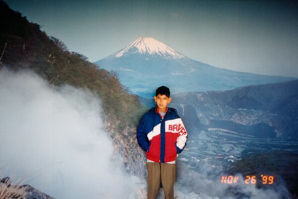 AJC photojournalist Arvin Temkar poses for a family photo against the backdrop of Mount Fuji in Japan in 1999. (Courtesy of Arvin Temkar)