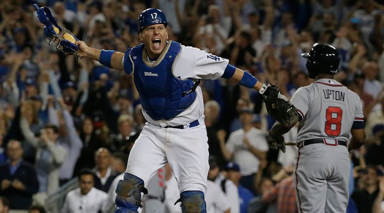 Los Angeles Dodgers catcher AJ Ellis celebrates as Atlanta Braves outfielder Justin Upton recorded the final out of Game 4 of the National League Division Series Monday in Los Angeles.