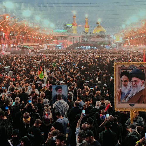 Shiite worshipers carrying a portrait of the late Iranian Supreme Leader Ayatollah Ali Khamenei and the late Iranian Leader Ayatollah Khomeini gather between the holy shrines of Imam Abbas and Imam Hussein during Arbaeen, marking the end of the 40-day mourning period following Ashoura, in Karbala, Iraq, Tuesday, Aug. 4, 2026. (AP Photo/Hadi Mizban)