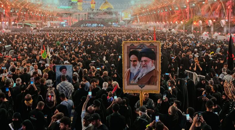 Shiite worshipers carrying a portrait of the late Iranian Supreme Leader Ayatollah Ali Khamenei and the late Iranian Leader Ayatollah Khomeini gather between the holy shrines of Imam Abbas and Imam Hussein during Arbaeen, marking the end of the 40-day mourning period following Ashoura, in Karbala, Iraq, Tuesday, Aug. 4, 2026. (AP Photo/Hadi Mizban)