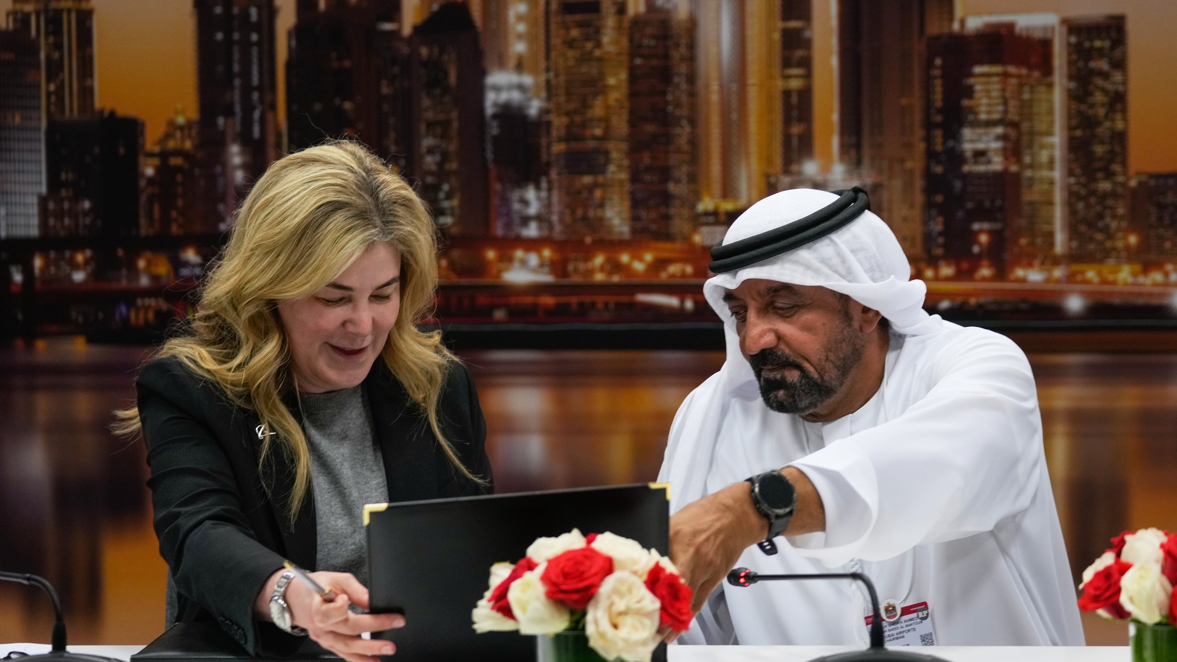 Stephanie Pope, President and CEO of Boeing Commercial Airplanes, left, and Sheikh Ahmed bin Saeed Al Maktoum, President, Dubai Civil Aviation Authority and Chairman of Emirates airlines, sign an agreement to order 65 additional Boeing 777X aircrafts during a press conference on the opening day of the Dubai Air Show, United Arab Emirates, Monday, Nov. 17, 2025. (AP Photo/Altaf Qadri)