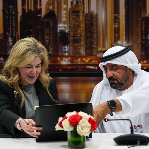 Stephanie Pope, President and CEO of Boeing Commercial Airplanes, left, and Sheikh Ahmed bin Saeed Al Maktoum, President, Dubai Civil Aviation Authority and Chairman of Emirates airlines, sign an agreement to order 65 additional Boeing 777X aircrafts during a press conference on the opening day of the Dubai Air Show, United Arab Emirates, Monday, Nov. 17, 2025. (AP Photo/Altaf Qadri)