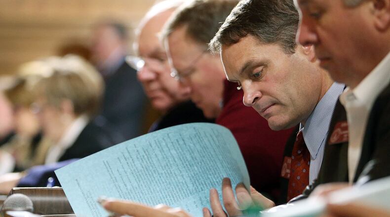 March 6, 2013 - Atlanta, Ga: Rep. Ed Setzler, R-Acworth, center, looks over bills and resolutions to be considered for Crossover Day with fellow representatives during the House Rules Committee at the Capitol Wednesday morning in Atlanta, Ga., March 6, 2013. The House Rules Committee met to discuss more than 60 bills and resolutions to be considered for the calendar for Crossover Day. Crossover Day is the day when a bill must pass either the House of the Senate in order to be considered by the other body this session. If a bill doesn't pass somewhere by Thursday, it is dead for this session. JASON GETZ / JGETZ@AJC.COM