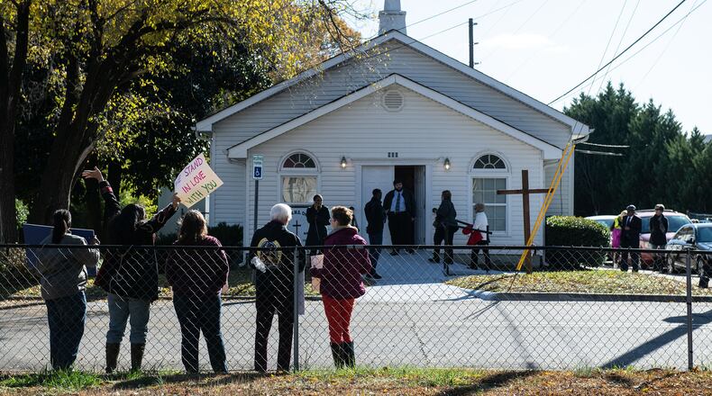 Supporters hold signs across the street from Bethel African Methodist Episcopal Church in Gainesville last year after police foiled a teen girl's plot to kill Black parishioners.