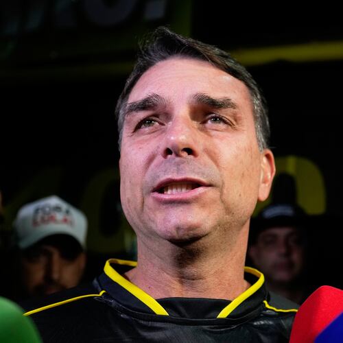 Flavio Bolsonaro, son of ex-President Jair Bolsonaro, speaks during a vigil outside the former president's residence in Brasília, Brazil, Saturday, Nov. 22, 2025, after his father's arrest earlier in the day, carried out days before he was set to start serving his 27-year sentence for leading a coup attempt. (AP Photo/Eraldo Peres)