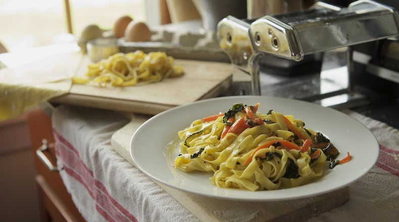 Veggie Carbonara features homemade fettucine, kale, carrots and a rich sauce of cream, Asiago, egg yolks and fresh oregano. Photo credit: Tom Brodnax. Styling credit: Laurie and Will Moore