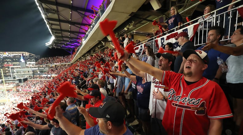 Braves fans participate in the tomahawk chop before a 2018 playoff game at SunTurst Park (now Truist Park).