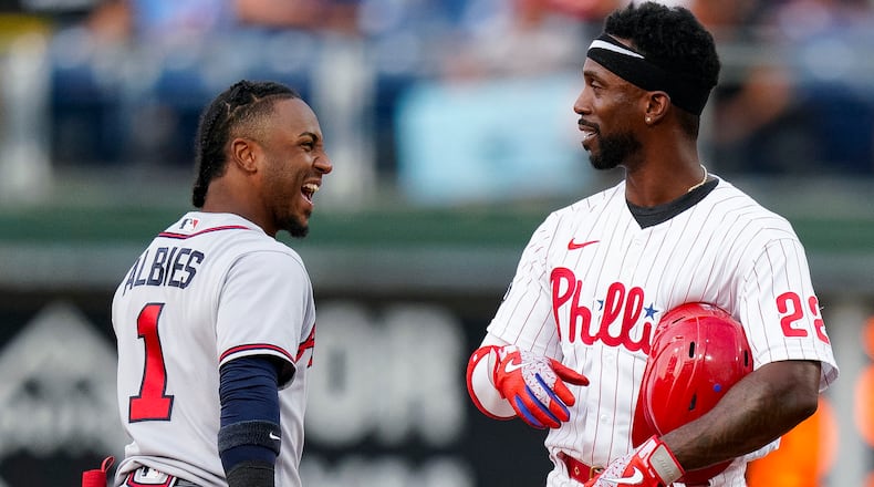 Philadelphia Phillies' Andrew McCutchen (right) talks with Braves second baseman Ozzie Albies during game, Saturday, July 24, 2021, in Philadelphia. (Chris Szagola/AP)