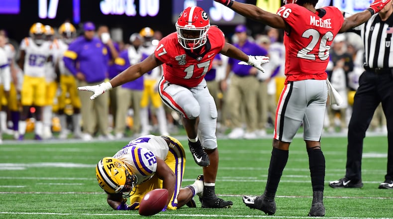 12/7/19 - Atlanta -  Georgia Bulldogs defenders Nakobe Dean (17) and Tyrique McGhee (26) signal as LSU Tigers running back Clyde Edwards-Helaire (22) misses a throw during the first half of the Georgia vs. LSU SEC Football Championship game at Mercedes-Benz Stadium in Atlanta.  Hyosub Shin / hyosub.shin@ajc.com