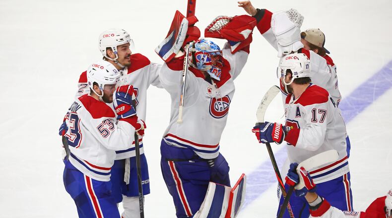 Montreal Canadiens players celebrate victory following the overtime period in Game 7 of a second-round NHL hockey Stanley Cup playoff series against the Buffalo Sabres, Monday, May 18, 2026, in Buffalo, N.Y. (AP Photo/Jeffrey T. Barnes)