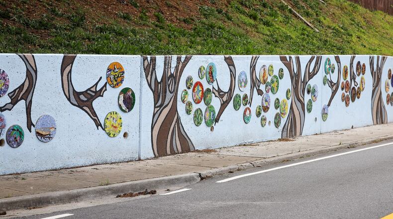 Led by Jennifer Freeman, mosaic artist and advisor for the project, and local artist and Norcross Elementary teacher Bobbie Adamczyk, the Mitchell Mosaic consists of over 125 mosaic disks installed on 5 panels stretching 130 feet long. (Courtesy City of Norcross)