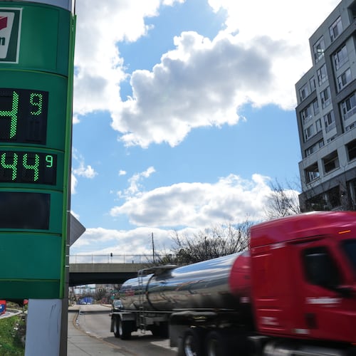 FILE - Fuel prices are displayed on a sign at a gas station as a fuel truck drives by, March 17, 2026, in Baltimore. (AP Photo/Stephanie Scarbrough, File)