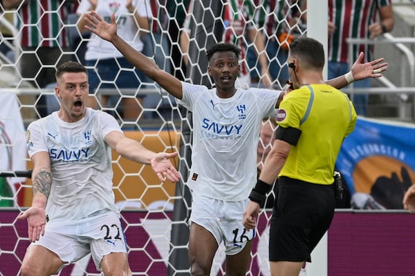 Al Hilal's Sergej Milinkovic-Savic, left, and Al Hilal's Nasser Al-Dawsari complain to the referee during the Club World Cup quarterfinal soccer match between Fluminense and Al Hilal in Orlando, Fla., Friday, July 4, 2025. (AP Photo/Phelan M. Ebenhack)
