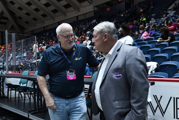 Kevin Gerke (left), VP of local productions at GPB, talks with Tim Scott, executive director of GHSA, during the Class 5A Boys GHSA State Championship at the Macon Coliseum, Friday, March 13, 2026, in Macon. Alexander won 81-67 over Woodward Academy. (Hyosub Shin/AJC)
